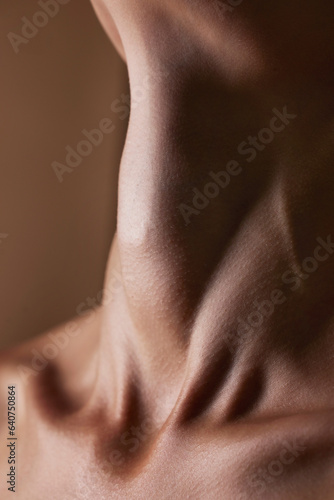 Health, beauty and closeup with neck of person in studio for skincare, textures and cosmetics. Wellness, body and aesthetic with zoom of woman on brown background for glow dermatology and glamour