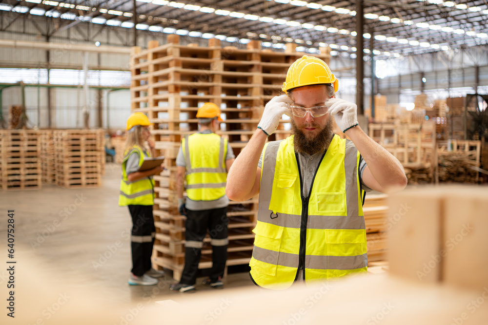 Young workers working in a woodworking factory, Using a hammer to work assembling pallet parts Young workers working in a woodworking factory, Using a hammer to work assembling pallet parts