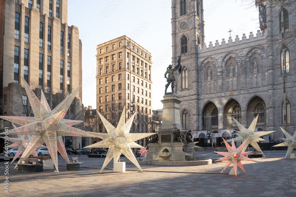 Fototapeta premium Old Montreal, Place d'Armes with Notre Dame Basilica in the background with Christmas decorations.