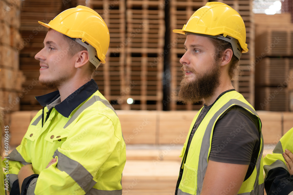 Group of workers in a large timber factory, Have fun by raising your arms after completing the day's work. Group of workers in a large timber factory, Have fun by raising your arms after completing the day's work.