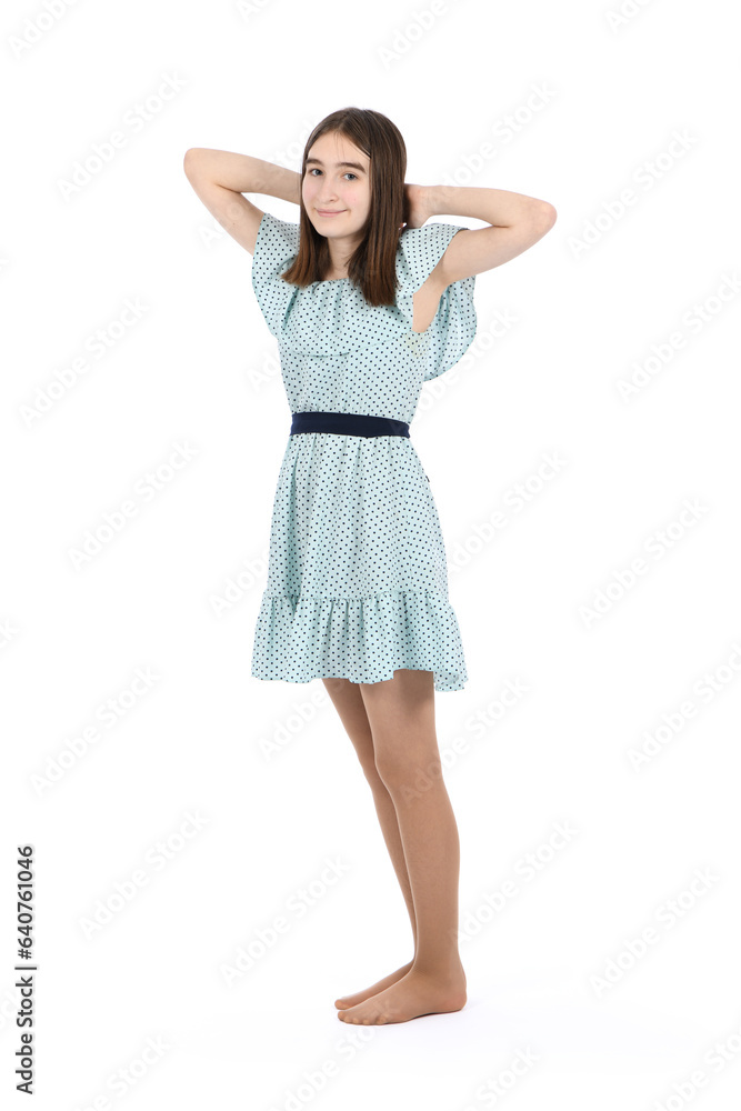 Young beautiful girl in a dress with polka dots on a white background. Young beautiful girl in a dress with polka dots on a white background.