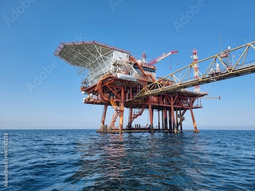 Photograph taken during the day of one of the many platforms in the middle of the Adriatic Sea, used for the exploitation of the natural resources beneath them. Photo taken in August 2023. photo