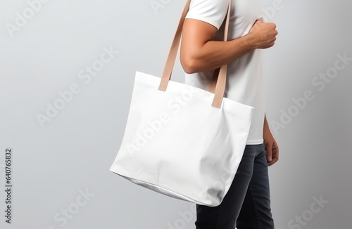 Man holding blank empty canvas bag for shopping, eco friendly concept