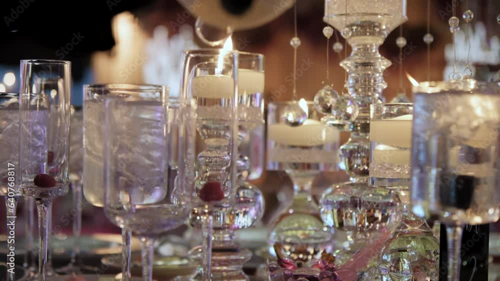 The waiter pours the alcoholic beverages into the glasses at the banquet. Close up The waiter pours the alcoholic beverages into the glasses at the banquet. Close up