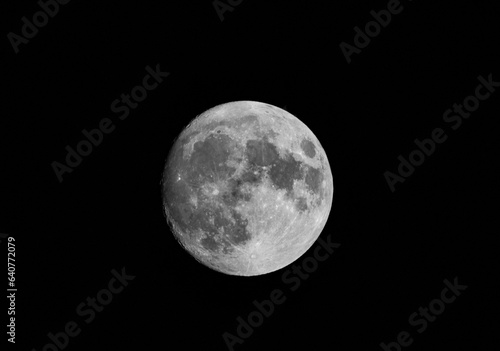 The waxing gibbous moon is a captivating celestial marvel, gracefully transitioning from the crescent phase to its full splendor. Its luminous face is imbued with an ever-increasing glow. photo