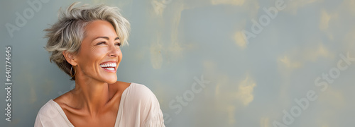 Beautiful senior model woman with grey hair smiling and laughing emphasizing healthy skin and dental care 
