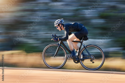 Fototapeta Naklejka Na Ścianę i Meble -  Motion blur, speed and cyclist on bicycle on road in mountain with helmet, exercise adventure trail and fitness. Cycling race, nature and man with bike for fast workout, training motivation or energy