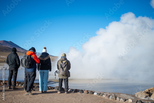 four people observing a gayser at El Tatio, Antofagasta, Atacama, Chile
