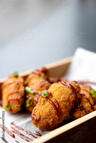 grilled chicken wings with sauce and scallions
