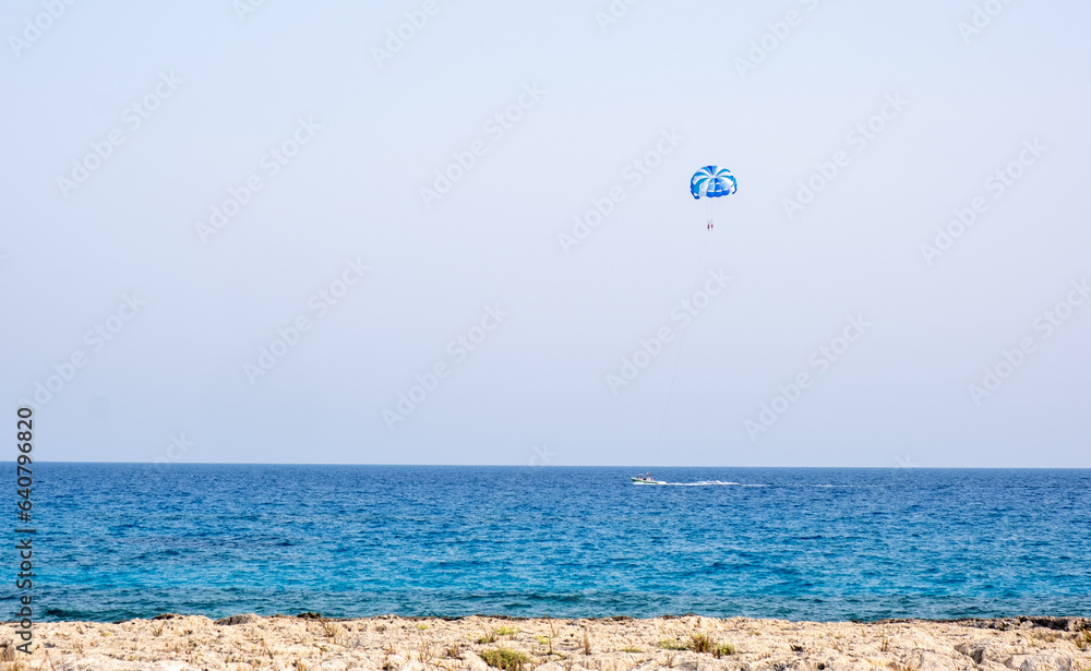 Tourist people parasailing in the sea. Summer entertainment holidays, extreme sports outdoor Tourist people parasailing in the sea. Summer entertainment holidays, extreme sports outdoor
