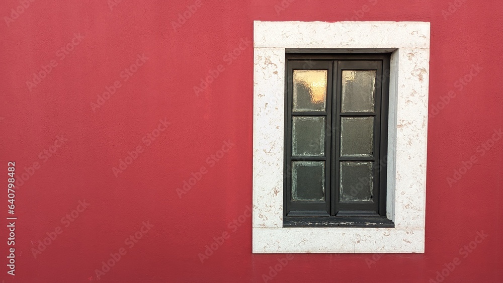 Wooden old window in an old castle with red walls and a stone window frame Wooden old window in an old castle with red walls and a stone window frame