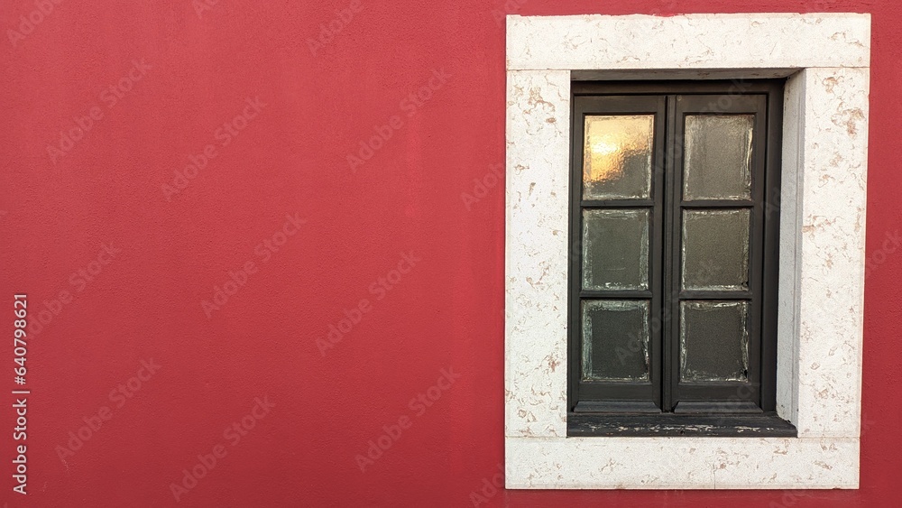 Wooden old window in an old castle with red walls and a stone window frame Wooden old window in an old castle with red walls and a stone window frame