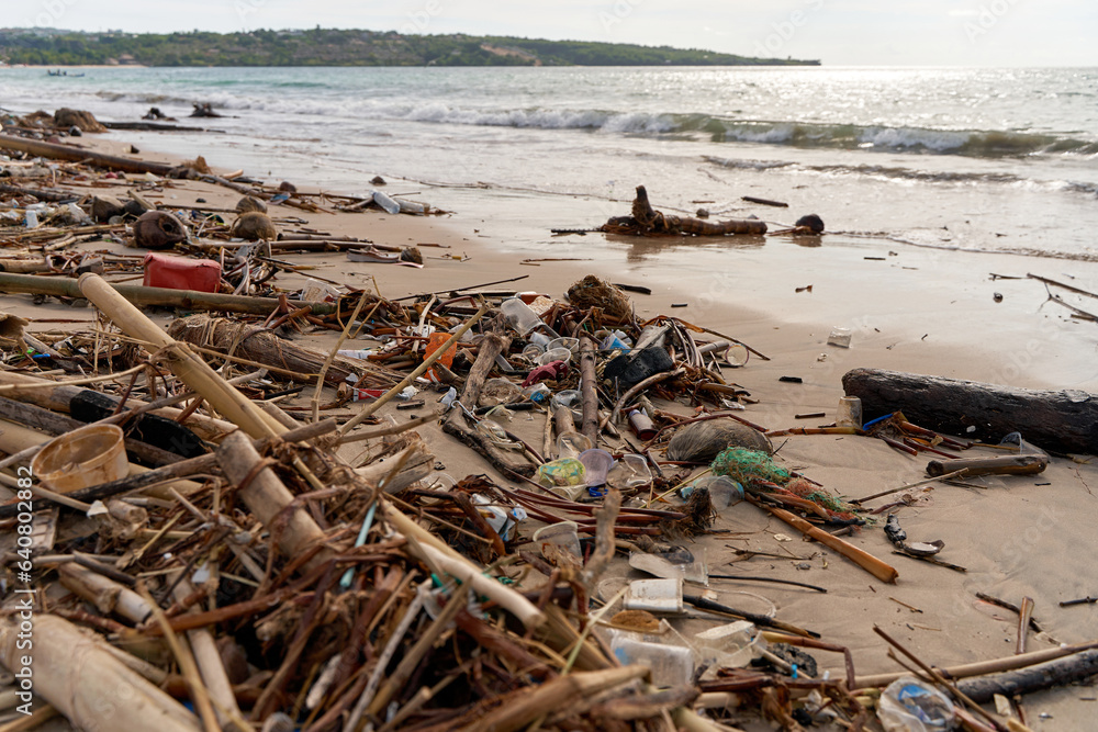 Mountains of waste and garbage on the sandy beach after the tide. Humanity is polluting the ocean Mountains of waste and garbage on the sandy beach after the tide. Humanity is polluting the ocean