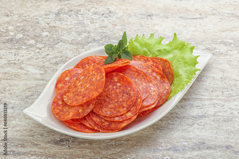 Sliced pepperoni sausage in the bowl Sliced pepperoni sausage in the bowl