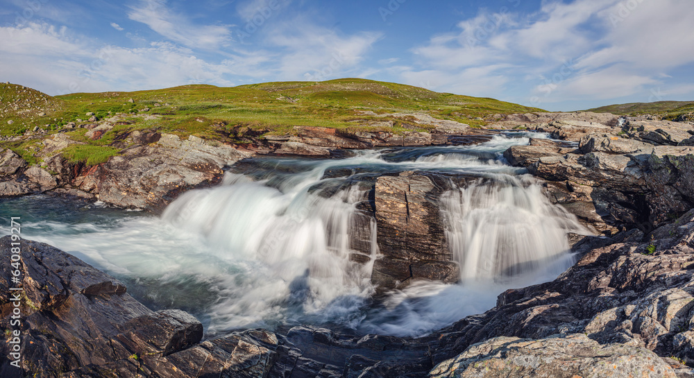 Long exposure image of a small waterfall on a high altitude plateau, the fjäll, in the mountains of central Sweden Long exposure image of a small waterfall on a high altitude plateau, the fjäll, in the mountains of central Sweden