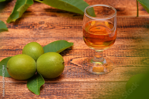 Принти на полотні drink from green walnuts and branches on the table