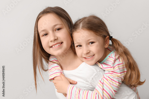 Cute little sisters hugging...