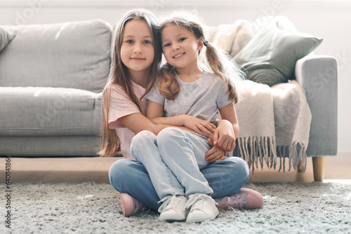 Cute little sisters hugging...