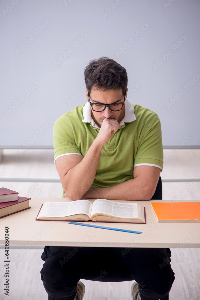 Young male student sitting in the classroom Young male student sitting in the classroom