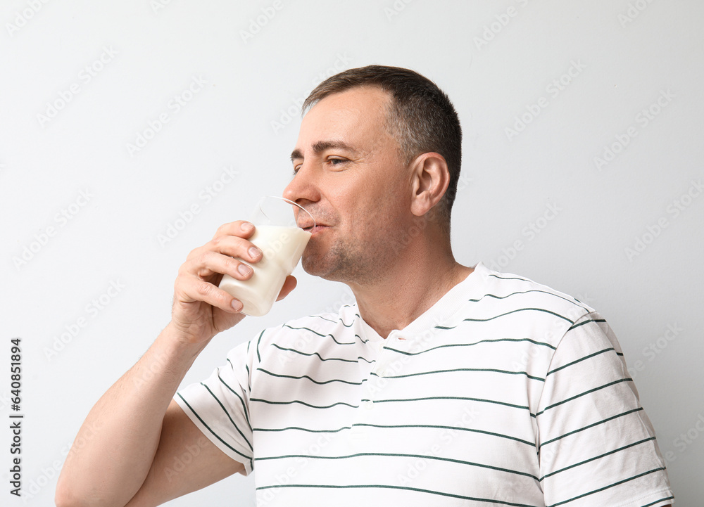 Mature man drinking milk on white background Mature man drinking milk on white background