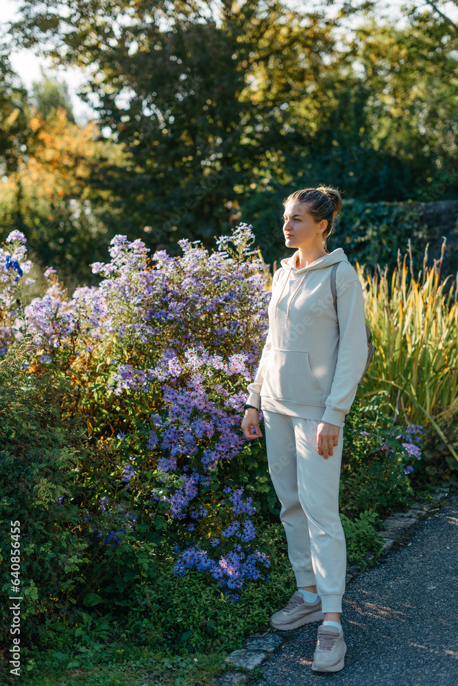 Beautiful elegant woman standing in autumn park with yellow leaves outdoor. Beauty Romantic Girl Outdoors enjoy autumn yellow leaves. Portrait of joyful woman in park during fall. Happy ng nature. Sun Beautiful elegant woman standing in autumn park with yellow leaves outdoor. Beauty Romantic Girl Outdoors enjoy autumn yellow leaves. Portrait of joyful woman in park during fall. Happy ng nature. Sun