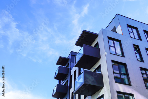 Look up to white appartment building with balconies towards blue sky. Kalamaja, Tallinn, Estonia