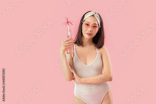 Young asian woman in swimsu...