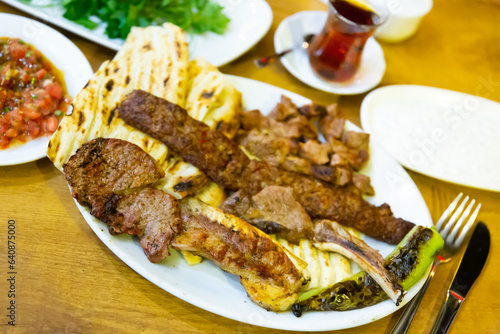 Kirmizi et tabagi. Plate with fried meat, pita bread and stewed peppers. Turkish cuisine photo