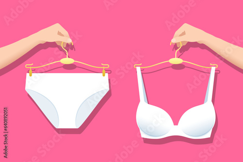Panty and bra in white color on hangers in hands of woman
