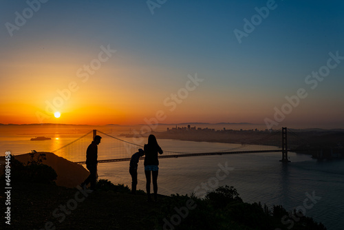 People enjoying the sunrise landscape of the Golden Gate Bridge