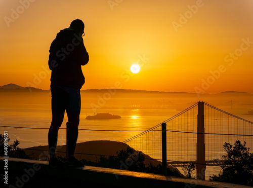 People enjoying the sunrise landscape of the Golden Gate Bridge