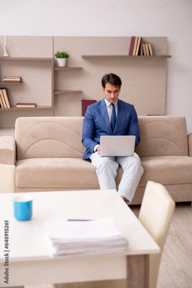 Young male employee working from home during pandemic Young male employee working from home during pandemic