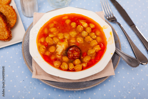 National Spanish dish of Garbanzos a la riojana in a ceramic bowl. Served with bread. photo