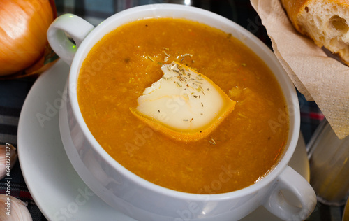 Appetizing vegetable soup puree served with cheese in bowl