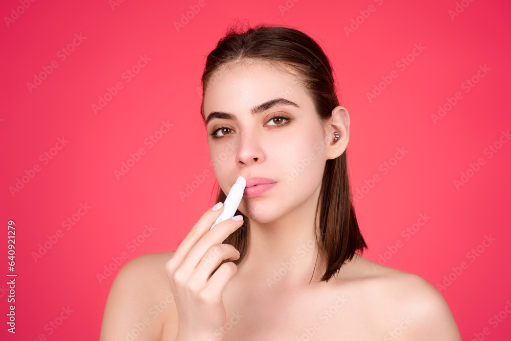 Beautiful young woman applying red lipstick on lips, studio color background. Sexy girl applied lipstick. Young nodel holding pink lipstick. Red lips make up. Beautiful woman putting lipstick on lips. Beautiful young woman applying red lipstick on lips, studio color background. Sexy girl applied lipstick. Young nodel holding pink lipstick. Red lips make up. Beautiful woman putting lipstick on lips.