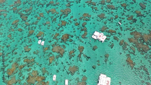 Amazing view of coral reefs of Maracajau with many tourists swiming and scuba diving and boats on the open ocean. Natal, Rio Grande do Norte, Brazil  photo