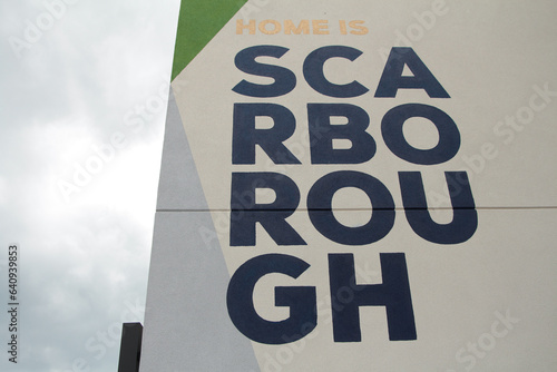 Photography scarborough text caption writing written on side of building in four lines rows