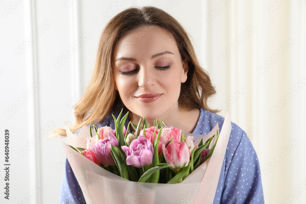 Young woman with bouquet of beautiful tulips indoors Young woman with bouquet of beautiful tulips indoors