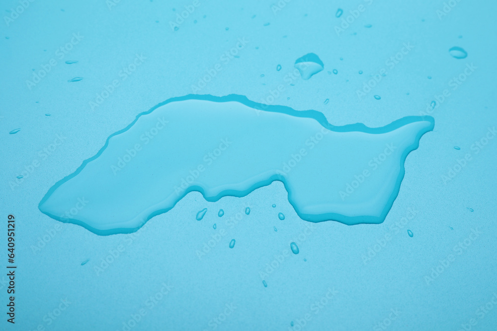 Obraz premium Puddle of water on light blue background, above view