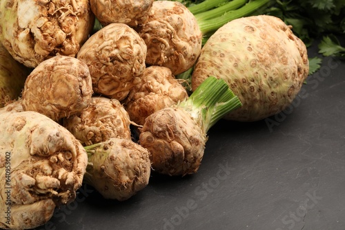 Fresh raw celery roots on black table, closeup