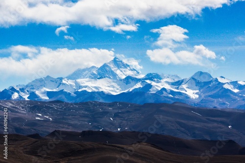 Breathtaking panoramic view of the majestic Mt. Everest, captured from the serene Pang La Pass (5205 m) in Shigatse, Tibet, during a sun-kissed winter day. 