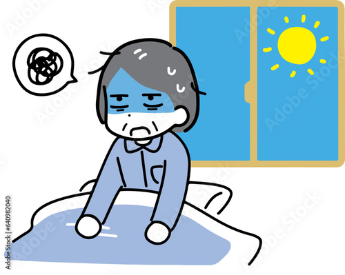 朝の布団の中で疲れた顔をしているパジャマのシニア女性(上半身)