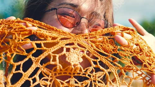 Happy free asian woman walking in tall grass on a sunny summer day. Portrait of a hippie woman in a bright orange boho style top photo