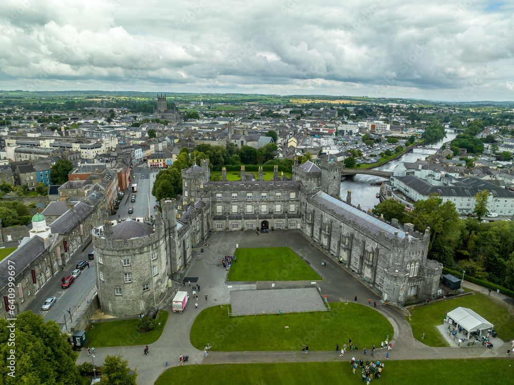 Aerial view of Kilkenny castle, Victorian remodeling of a medieval defensive structure, rolling parkland, terraced rose garden, woodlands, man-made lake by the Nore river