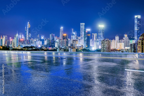Asphalt highway and urban skyline with modern buildings at night in Shenzhen, Guangdong Province, China. Road and city buildings after the rain. © ABCDstock