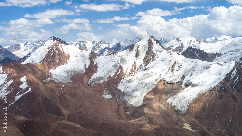 beautiful snowy mountain peaks in the clouds. highlands