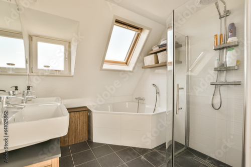 a modern bathroom with skylights on the window and tub in the shower is next to the sink  which has been used for