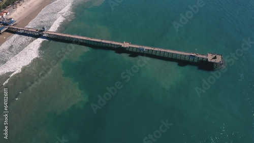 4K drone aerial tracking and stablishing shot of a beach with a pier in California photo