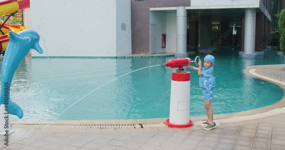 Happy boy and girl child playing in aquapark water splash gun with swimming pool summer vacation Happy boy and girl child playing in aquapark water splash gun with swimming pool summer vacation