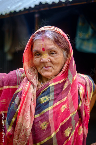 Portrait of a south asian elderly woman having white hair, hindu lady in traditional costume